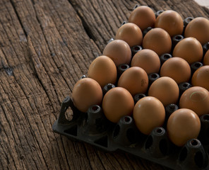 egg in tray on wooden table.