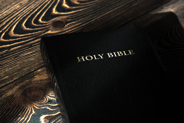 The Bible on the old wooden table, top view