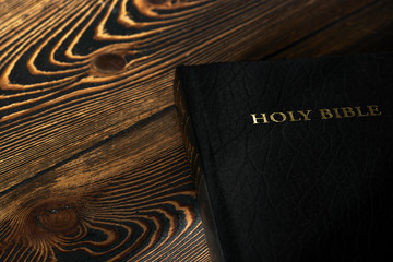 The Bible on the old wooden table, top view