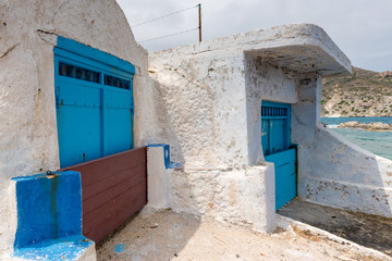 Fototapeta na wymiar Typical boat houses (sirmata) in Mandrakia village on Milos island. Cyclades, Greece.