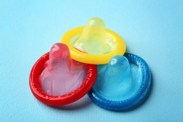 Colorful condoms on blue background.  Safe sex concept