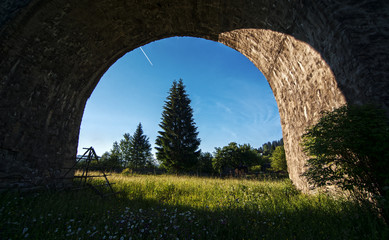 Arch of the stone bridge overlooking the valley