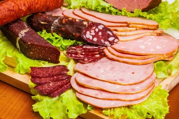 Meat and knife on the background of lettuce, cultivated mushrooms, olives in various angles