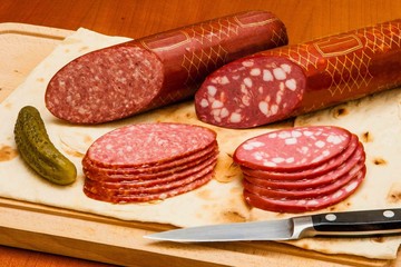 Meat and knife on the background of lettuce, cultivated mushrooms, olives in various angles