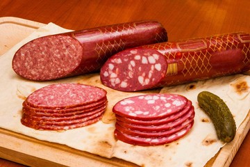 Meat and knife on the background of lettuce, cultivated mushrooms, olives in various angles