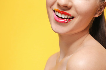 Woman with creative makeup on color background