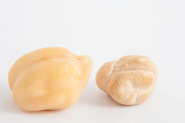 Comparison between dry and soaked chickpea on white background