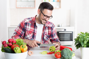 Man chopping vegetable in kitchen