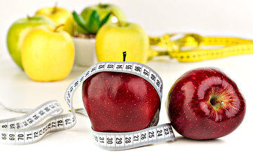 many ripe apples and a tape measure