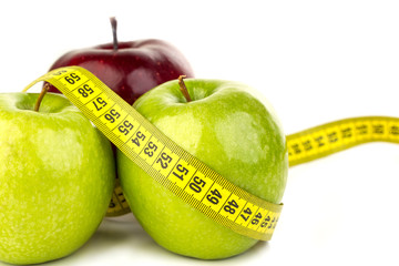 three ripe juicy apples and tape measure