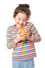 Naklejka premium Cute little girl with glass of juice on white background