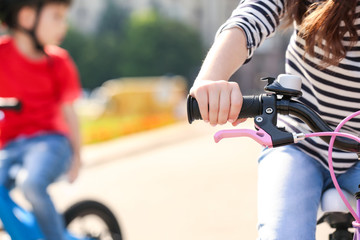 Naklejka premium Cute little child riding bicycle outdoors on sunny day, closeup