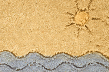 sea waves and sun drawing in sand