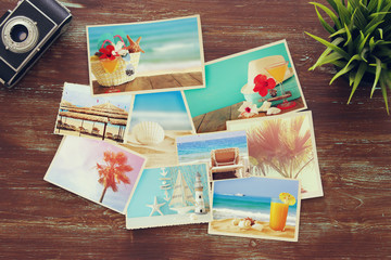 Fototapeta na wymiar top view of tropical photo collage on wooden background