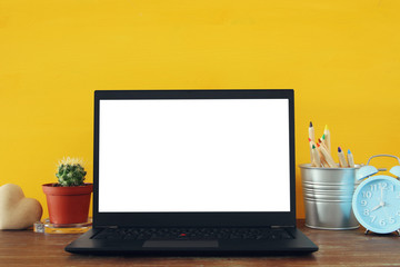 Fototapeta premium office work place with open leptop and empty white screen for copy space