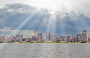 Obraz premium the cityscape in the background of the river with sun rays