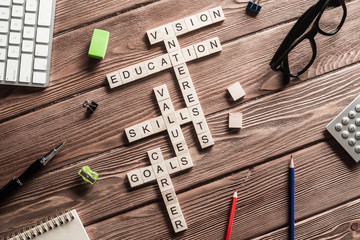 Fototapeta premium Conceptual keywords on wooden table with elements of game making crossword