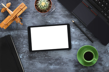 Top view of office work table with leptop, tablet, notebbok and cup of coffee