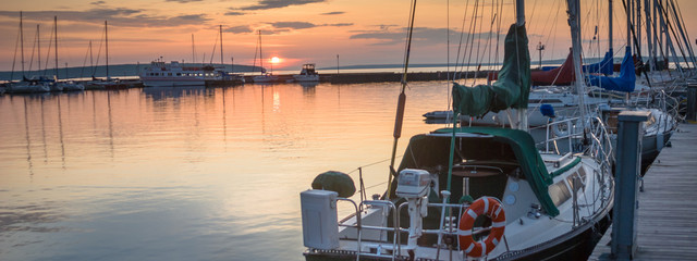 sailboats at sunrise in marina - 162842702