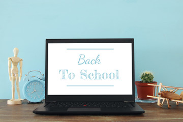 office work place with open leptop and empty white screen for copy space