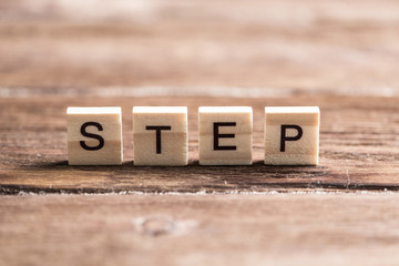Step word of wooden elements with letters