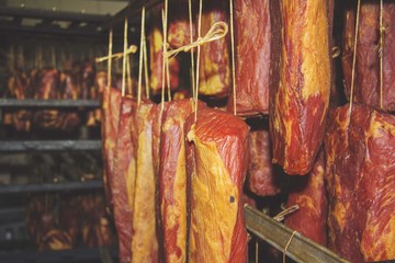 Fototapeta na wymiar smokehouse - Smoked meats - ham, bacon Assortment of cold meats, variety of processed cold meat products