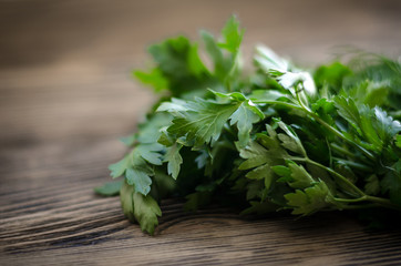 Fresh green dill and parsley herbs on rustic wooden table. Top view with copy space