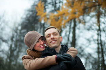  young couple in   autumn park.