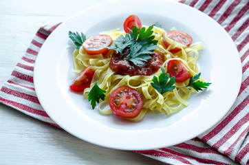 Pasta with sauce made of tomatoes, parsley, and basil