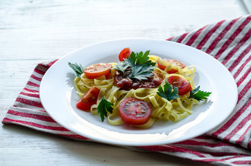 Pasta with sauce made of tomatoes, parsley, and basil
