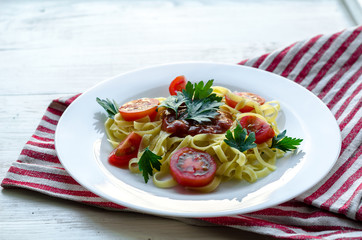 Pasta with sauce made of tomatoes, parsley, and basil