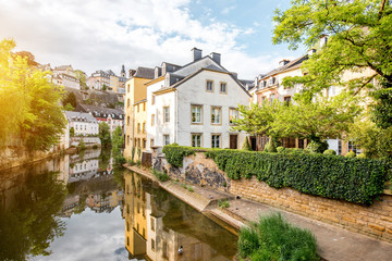 Fototapeta na wymiar Sunset view on the old buildings near the river in Grund district of the old town of Luxembourg city