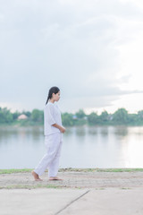Buddhist Nuns meditation walking in the temple of thailand.