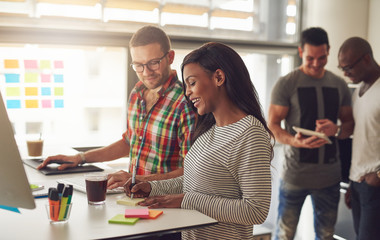 Fototapeta premium Cheerful young entrepreneurs working in the office