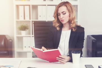 Red haired businesswoman with a planner