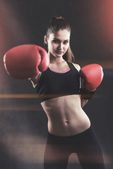 Portrait of a young woman in boxing gloves