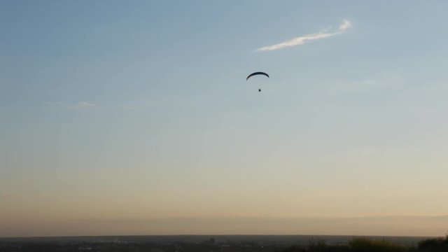 Silhouette of paraglider over the sunset