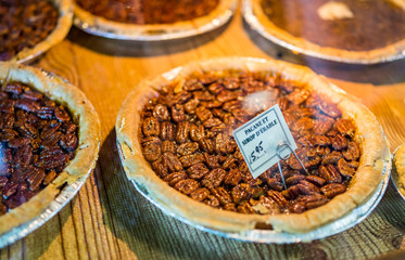 Macro closeup of display of pecan pies in market