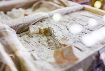 Macro closeup of tray of Turkish delight, lokum or rahat lokum candies on display in shop