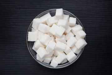 White sugar cubes on black background