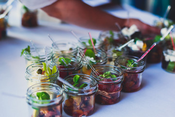 Decorated catering banquet table with different food appetizers assortment on a party
