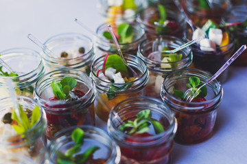Decorated catering banquet table with different food appetizers assortment on a party
