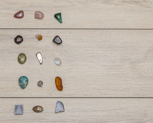 Semi-precious mineral collection on a wooden rustic table, free place for text. Top view