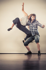 couple of young man and woman dancing hip-hop