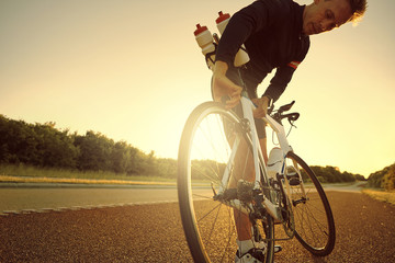 Man standing and setting bicycle on highway