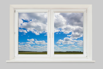 landscape from window with cloudy sky and field