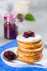 Homemade American pancakes served with red cranberry jam on blue napkin, Americal flag colors