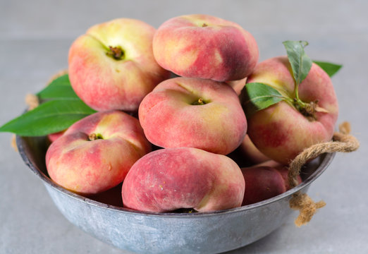 Fresh ripe chinese flat saturn peaches with leaves