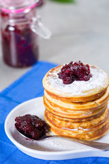 Homemade American pancakes served with red cranberry jam on blue napkin, Americal flag colors