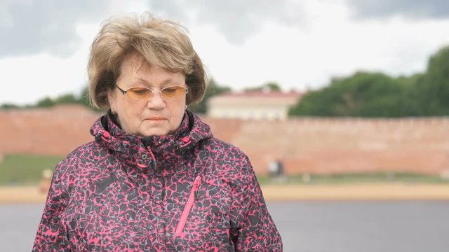 Black smartband. Outdoors adult woman looks at the results of physical activity using the smart fitness tracker. Slow motion